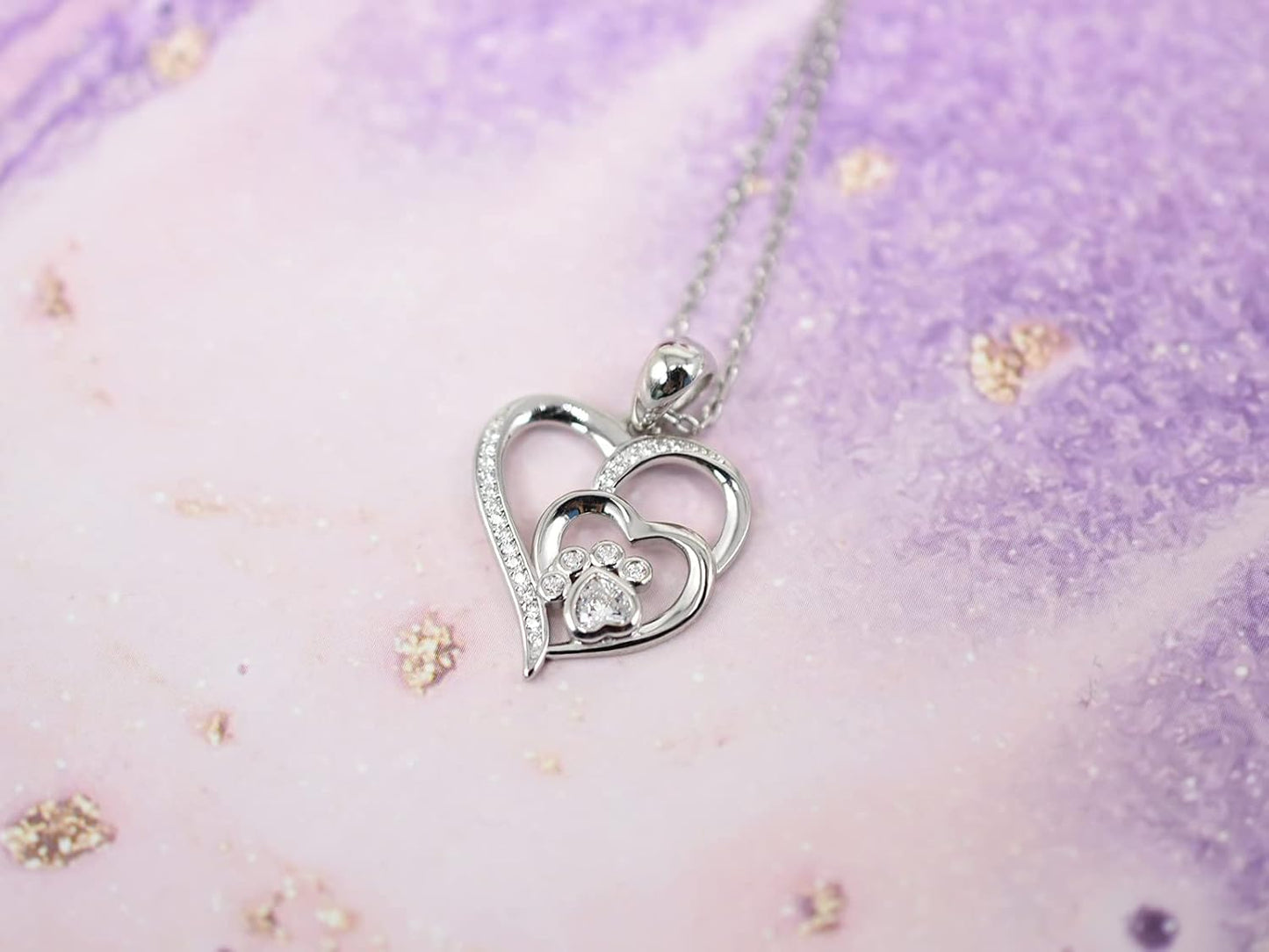 Sterling silver chain with paw print and heart, set with zirconia.