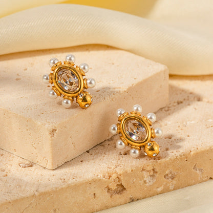 Eleganta örhängen i guld med pärla