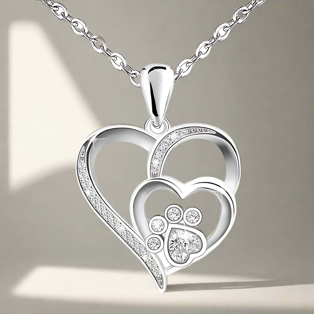 Sterling silver chain with paw print and heart, set with zirconia.