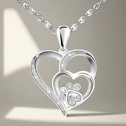Sterling silver chain with paw print and heart, set with zirconia.
